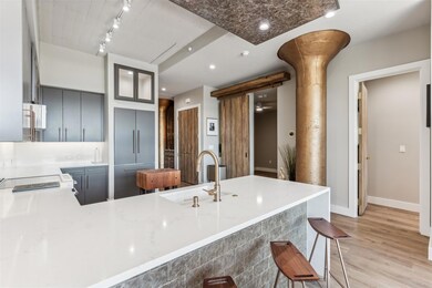 Kitchen featuring sink, kitchen peninsula, gray ca