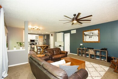 Another view of family room into large kitchen with built in island/breakfast bar.