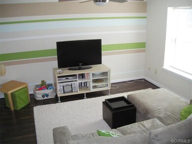 Living room has new floor and ceiling fan with lig
