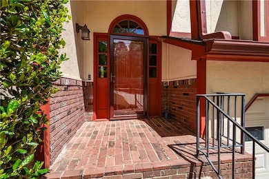 View of exterior entry featuring stucco siding and