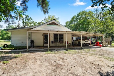 Charming 2-3 bedroom with 2 baths, covered porch and carport. Storage building directly behind the house.