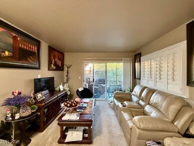 Living area featuring light carpet