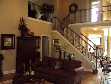 Another vilew of the great room showing off the catwalk and stairway to upstairs. (Photo of Decorated Model & For Representation Only)