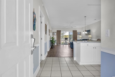 Kitchen featuring white cabinets, a peninsula, cro