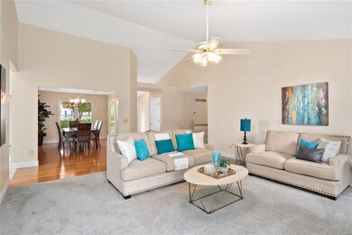 Great room has newer carpeting, vaulted ceiling, c