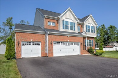 The brick-front and three car garage hint at the b