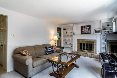 Cozy wood burning fireplace and built-in shelves