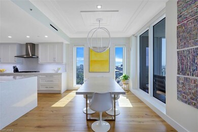 Dining room with a raised ceiling and light wood-style floors