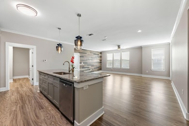 Kitchen featuring ornamental molding, gray cabinet