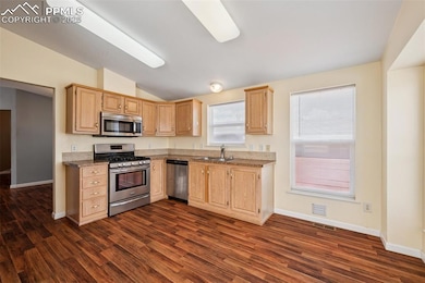 Kitchen features laminate flooring and breakfast nook