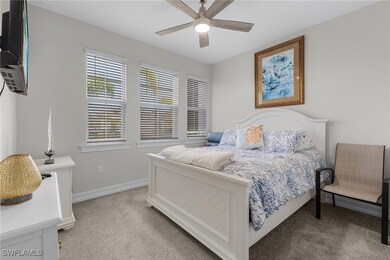 Bedroom featuring light carpet and ceiling fan