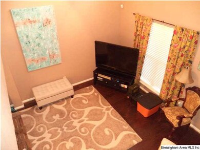 Family room has a vaulted ceiling and hardwood flo