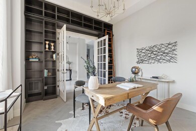 Office space featuring an inviting chandelier, ba
