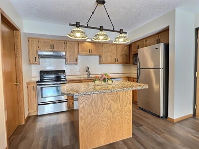 Kitchen island features a granite top