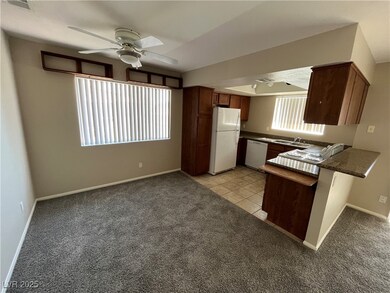 Kitchen featuring white appliances, ceiling fan, d