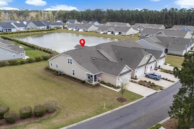 Bird's eye view featuring a water view and a resid