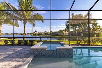 View of swimming pool featuring an in ground hot tub, a water view, and a lanai