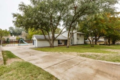 View of front facade featuring concrete driveway