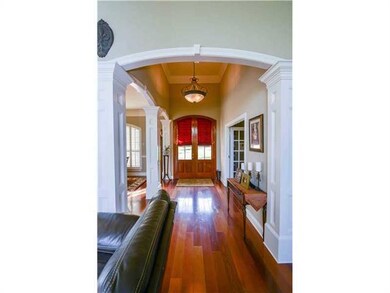 Photo. Open foyer, diningroom and den adorned with