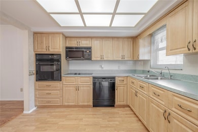 The kitchen features plenty of storage and prp areas with wood cabinets and solid surface counters.