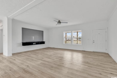 Unfurnished living room featuring light wood finis