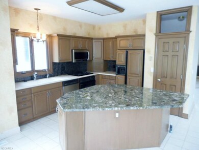 Kitchen with large granite island, ceramic tile fl