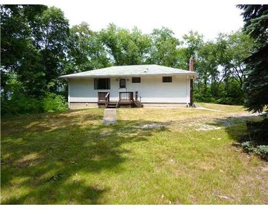 Exterior Back. SPACIOUS LEVEL YARD WITH SHED.