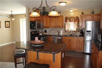 updated kitchen with island, granite counters and 
