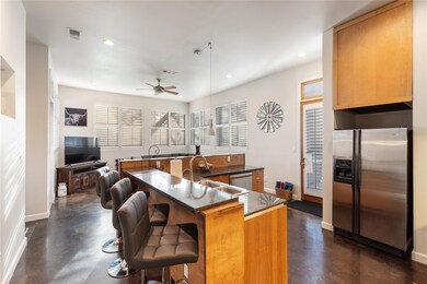 Kitchen featuring stainless steel fridge with ice