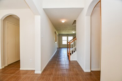 Entry way into the home, high ceiling entry with tile flooring throughout first floor.