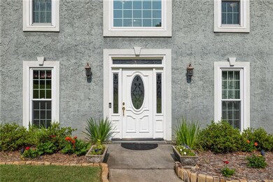 View of exterior entry with stucco siding