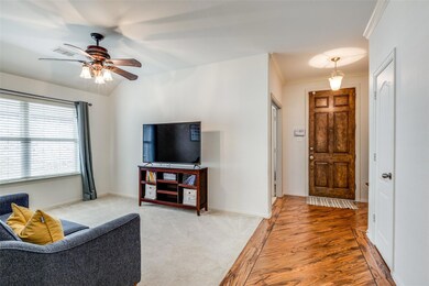 Living room with visible vents, a ceiling fan, lig