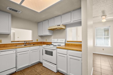Kitchen featuring light tile patterned floors, wh