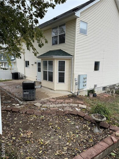 Back of house with a patio