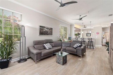 Living room with ceiling fan, ornamental molding, 