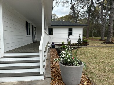 Professional, low-maintenance landscape design offers a welcoming entrance from the expansive driveway.