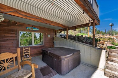 Lower covered patio with hot tub.