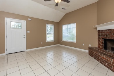 Unfurnished living room featuring light tile patterned floors, a fireplace, ceiling fan, and lofted ceiling