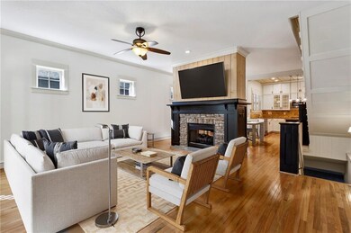 Living room with hardwoods and 2 sided fire place.