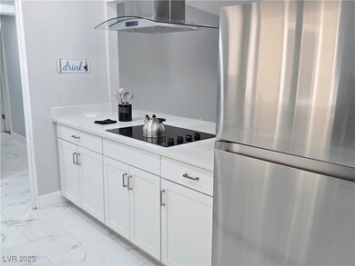 Kitchen with light countertops, freestanding refri