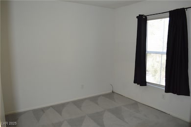 Carpeted empty room with baseboards