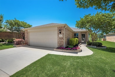 Single story home featuring a front yard and a gar