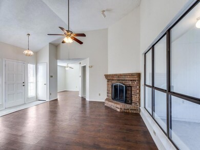 Unfurnished living room with vaulted ceiling, dark
