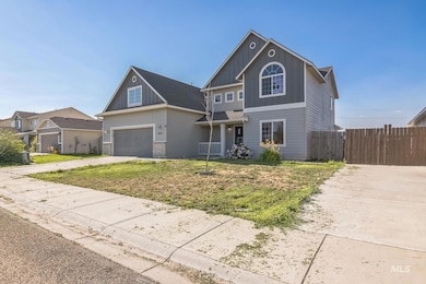 Traditional-style house with driveway, board and batten siding, and a garage