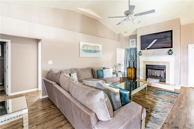 Living area featuring a ceiling fan, baseboards, a