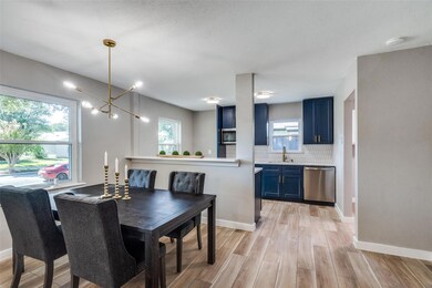 Dining area featuring sink, light hardwood / wood-