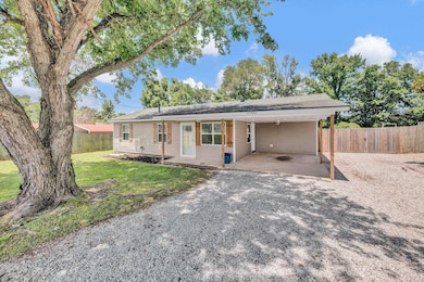 Ranch-style home featuring driveway and a carport
