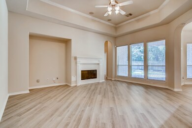 Tray ceilings in living room with crown molding