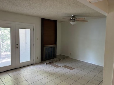 Unfurnished living room featuring french doors, l