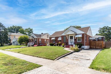 front of home showing sidewalks and driveway